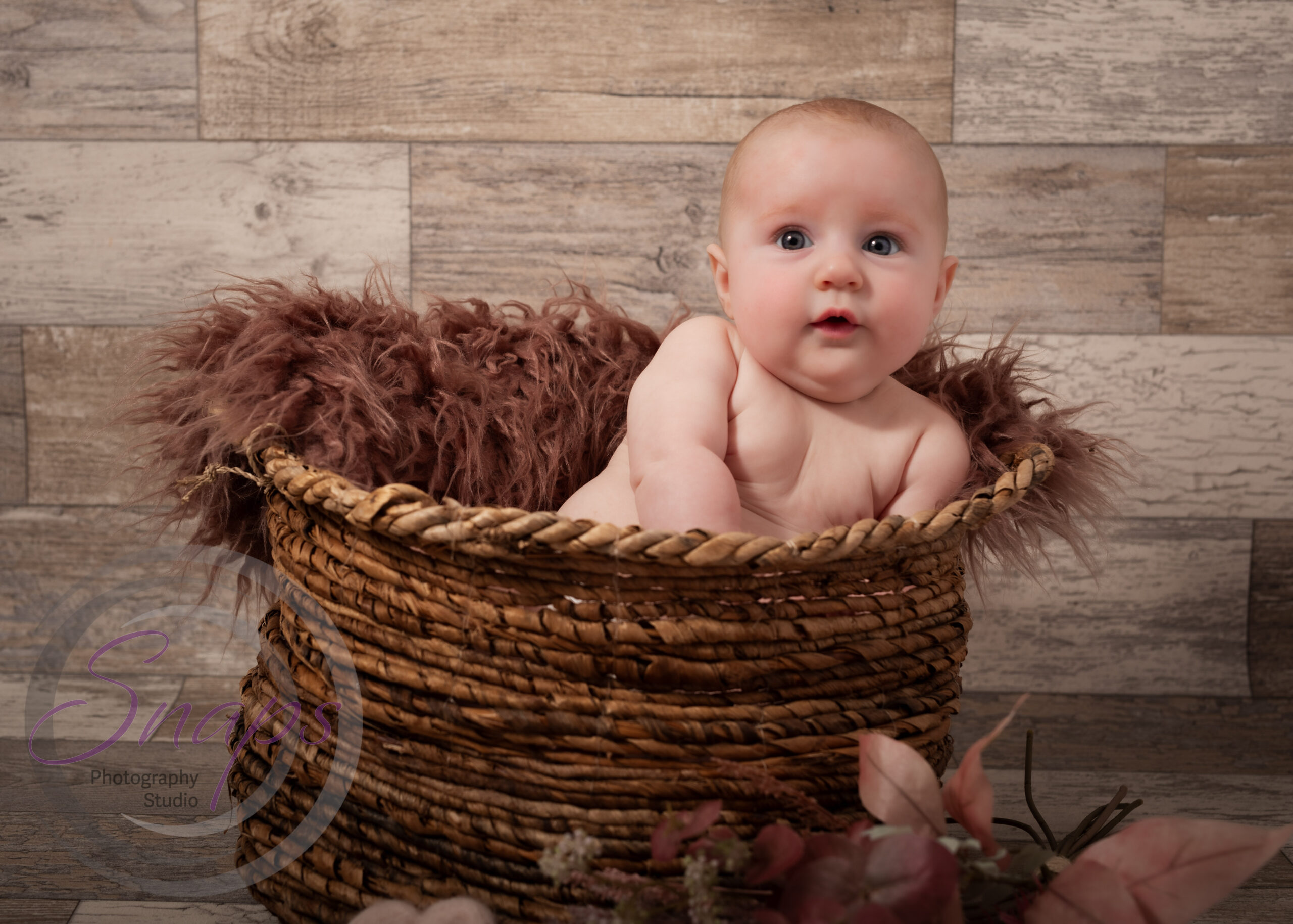 baby girl in a wicket basket