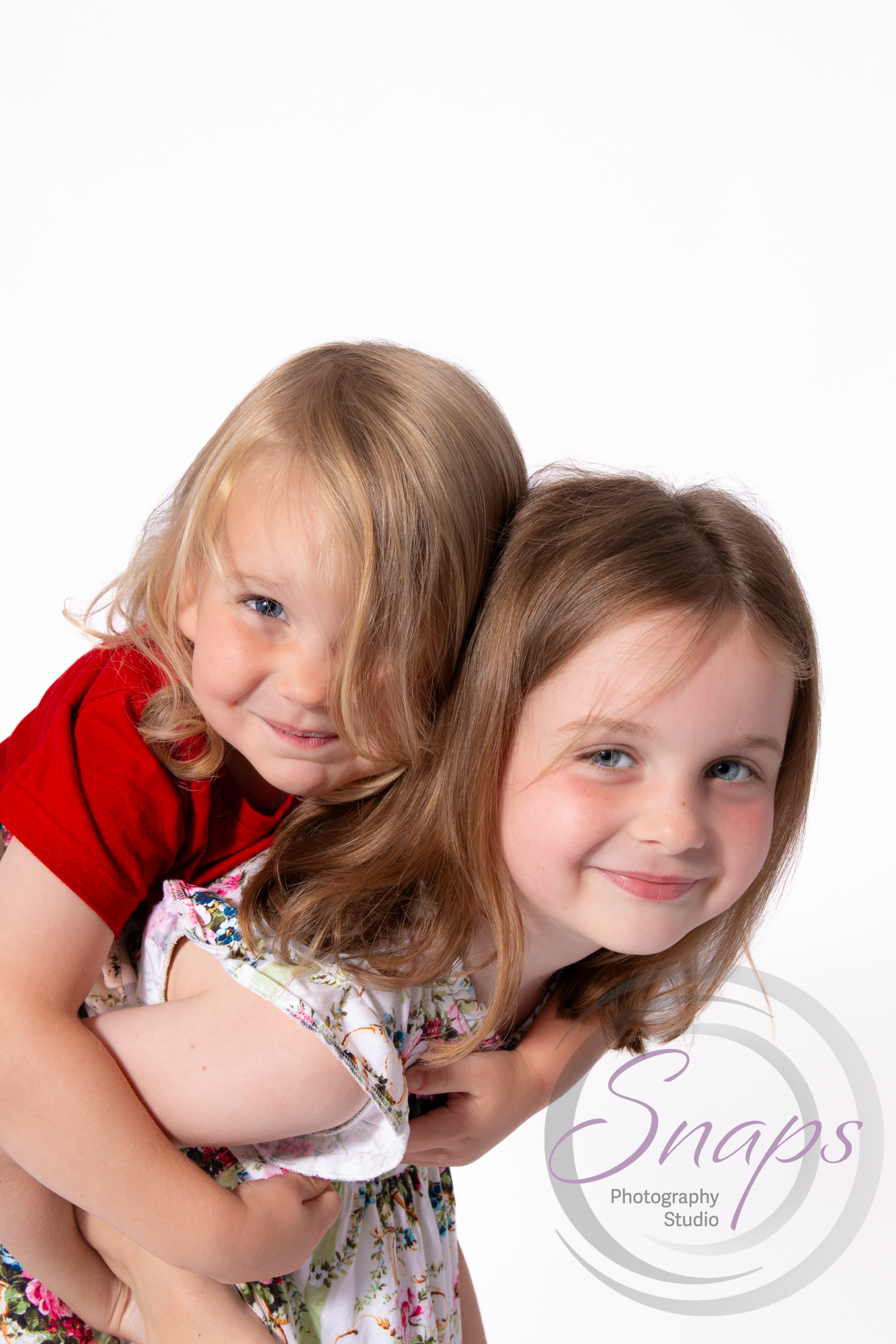 sibling piggyback at a photoshoot in stroud