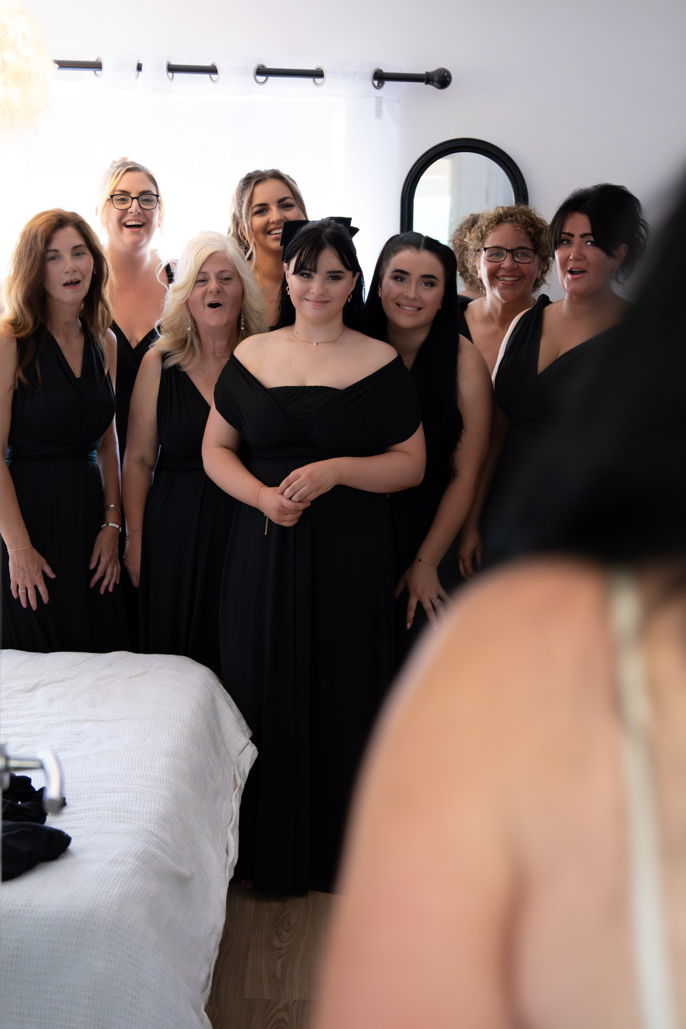 Bride revealing her dress to her bridesmaids