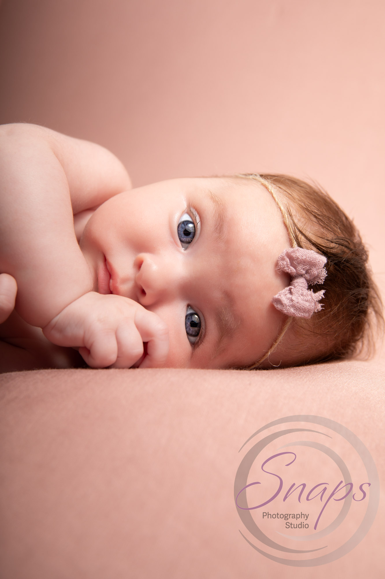 Baby pink photography wearing a bow in Nailsworth